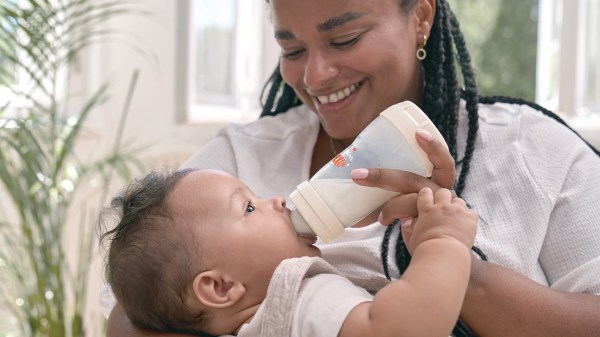 Mother feeding baby with MAM bottle