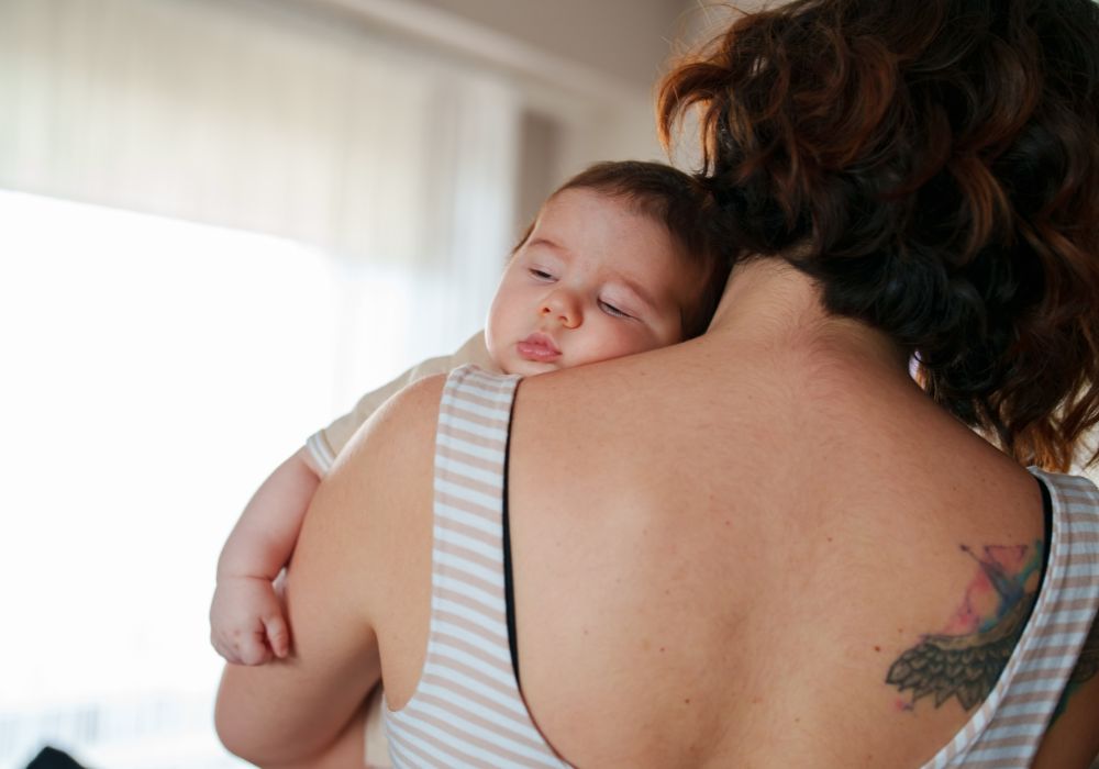 Baby sleeping on mother's shoulder