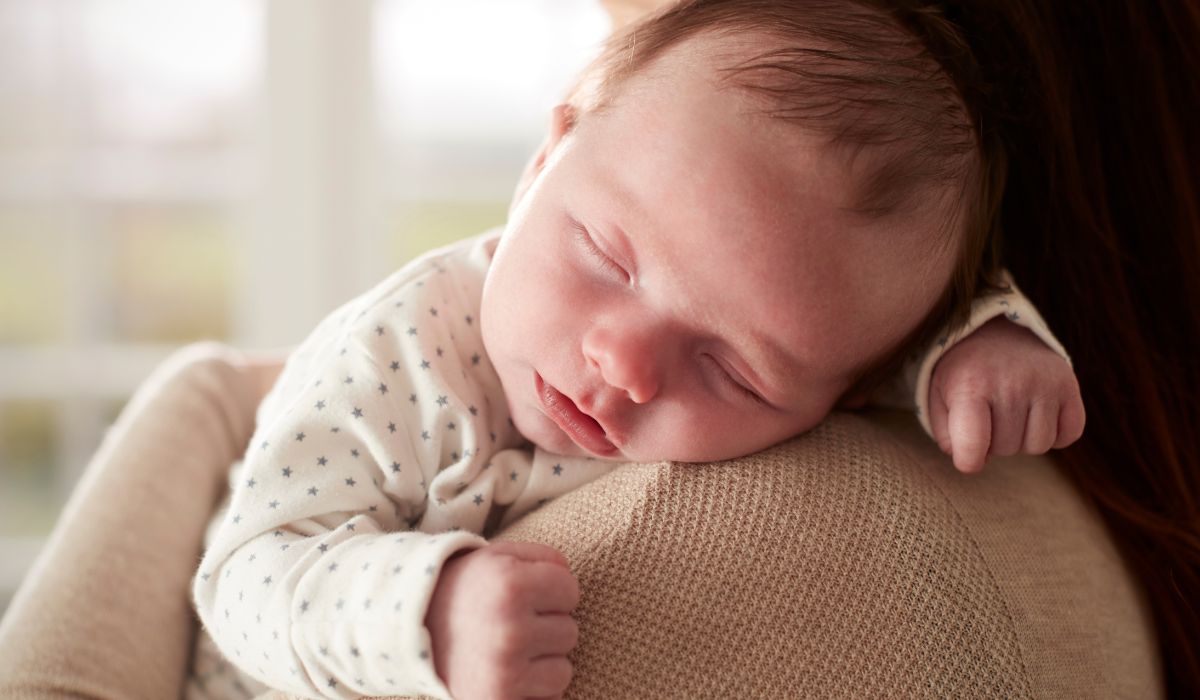 Baby sleeping on mother's shoulder