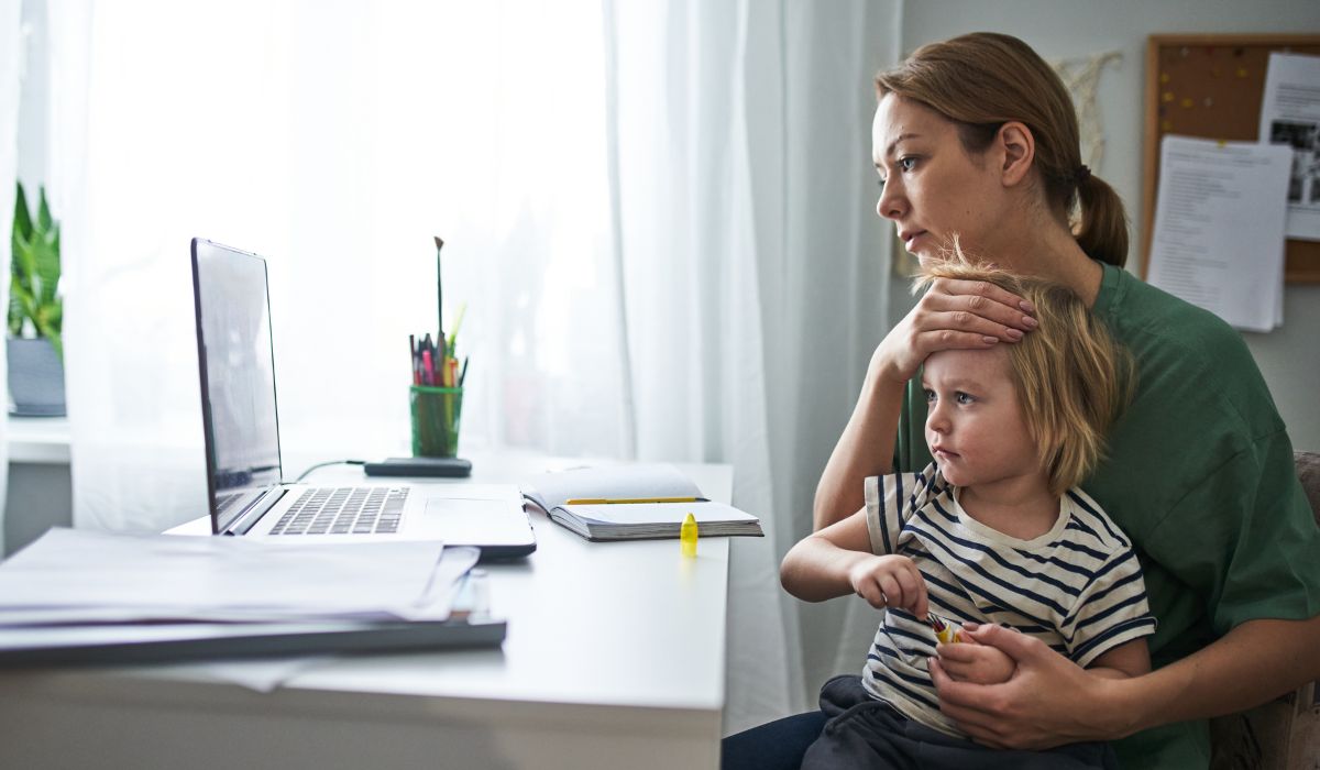 Mother trying to work with a sick child