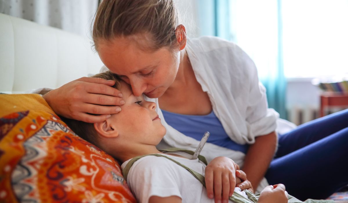 Mother kissing her sick child