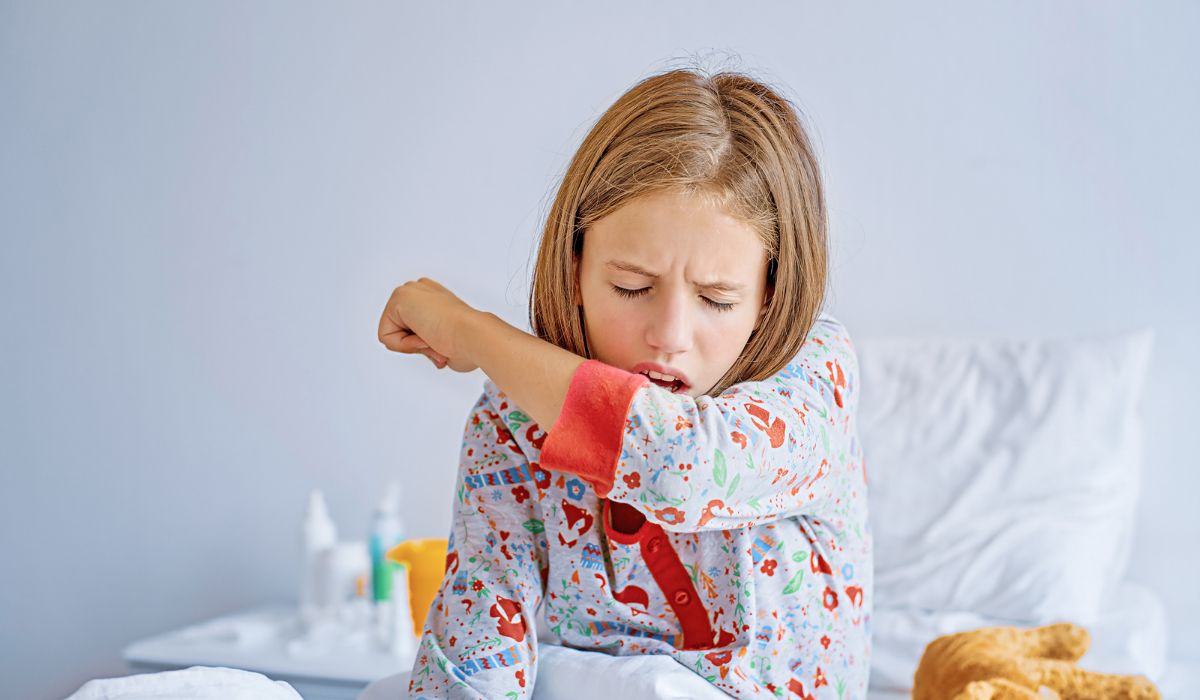 Coughing child in bed