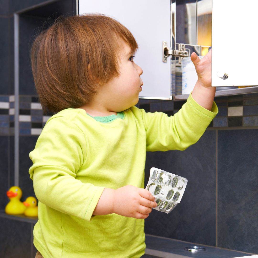child at the medicine cabinet