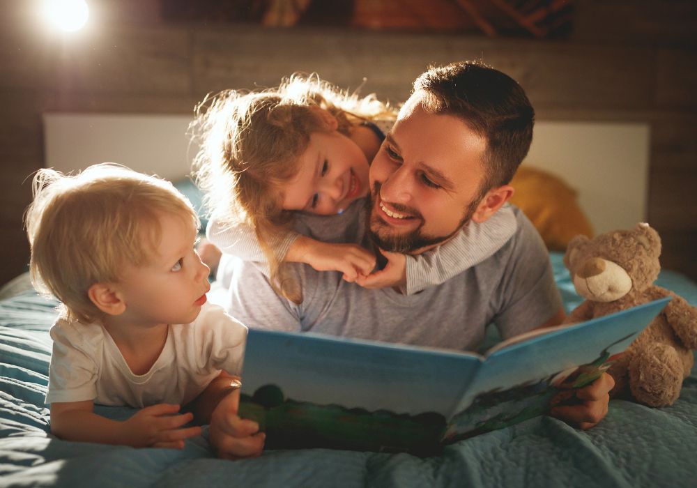 Father reading book to kids