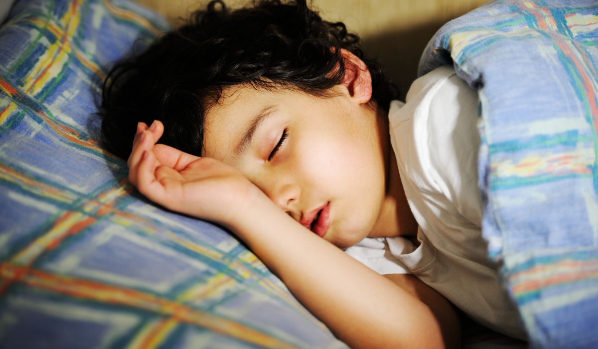 Little boy asleep in bed