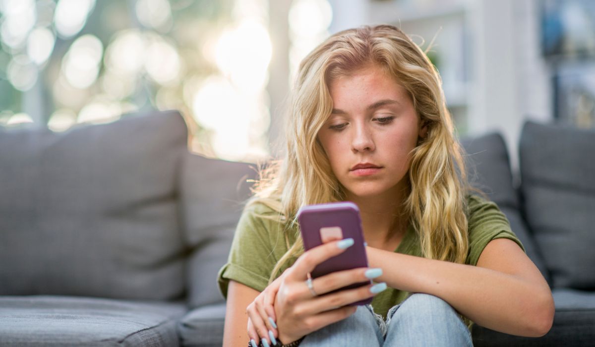 Sad teen on phone