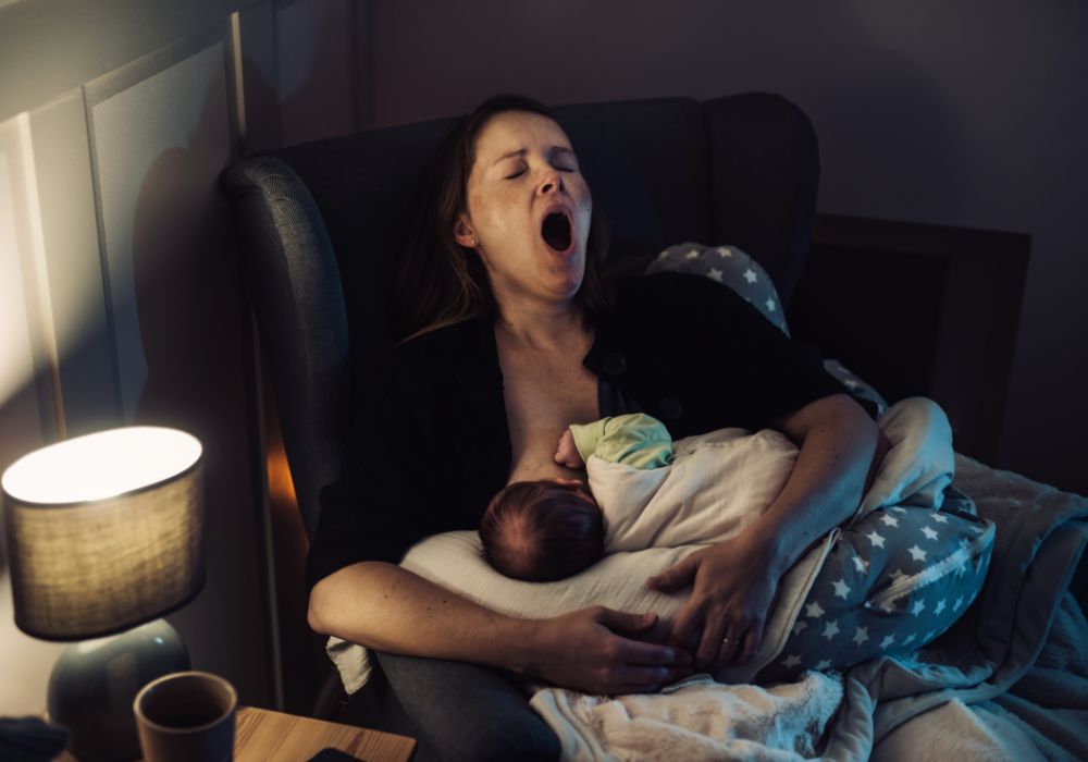 Mum breastfeeding and yawning