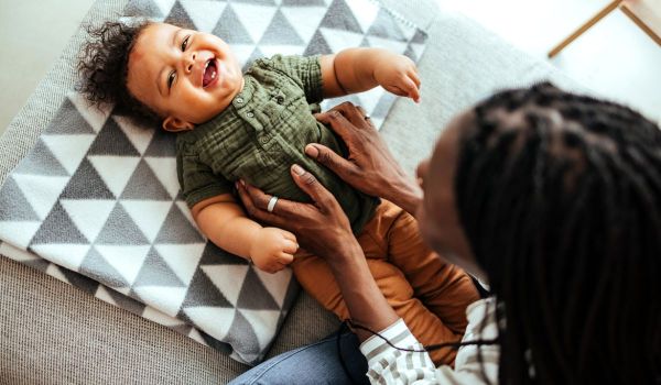 Mum playing with baby on the floor