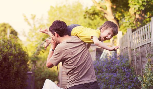 Dad carrying son on his shoulders
