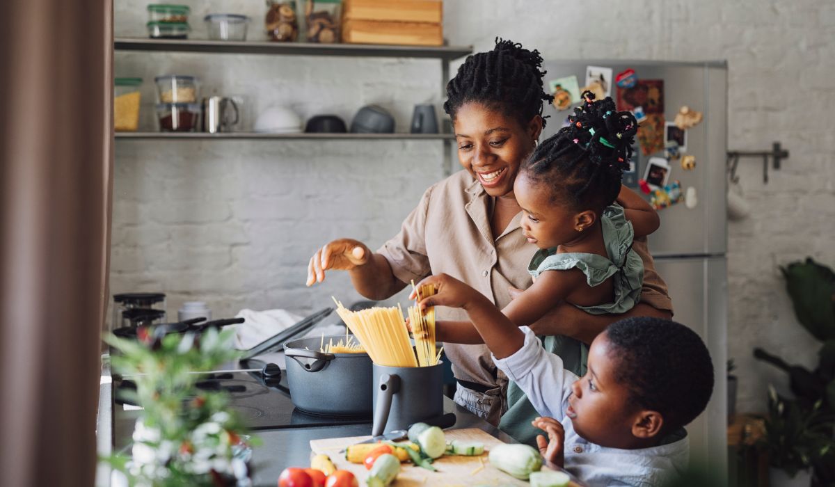 Mum and children cooking pasta together