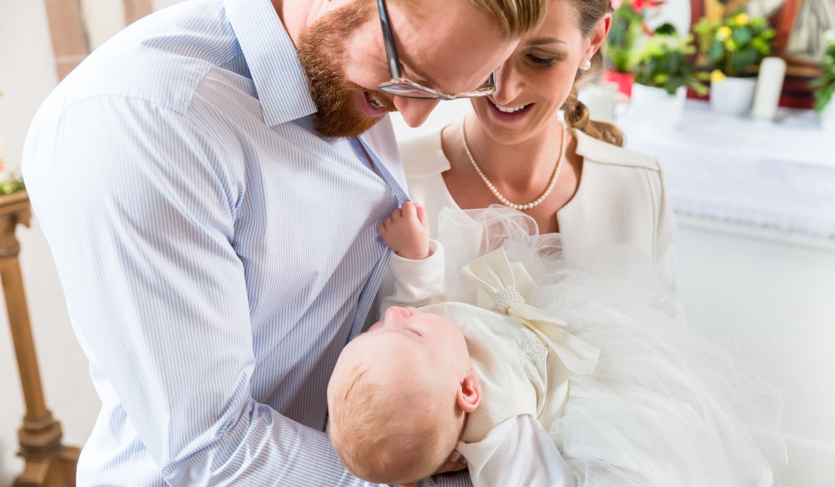 Couple with baby on christening day