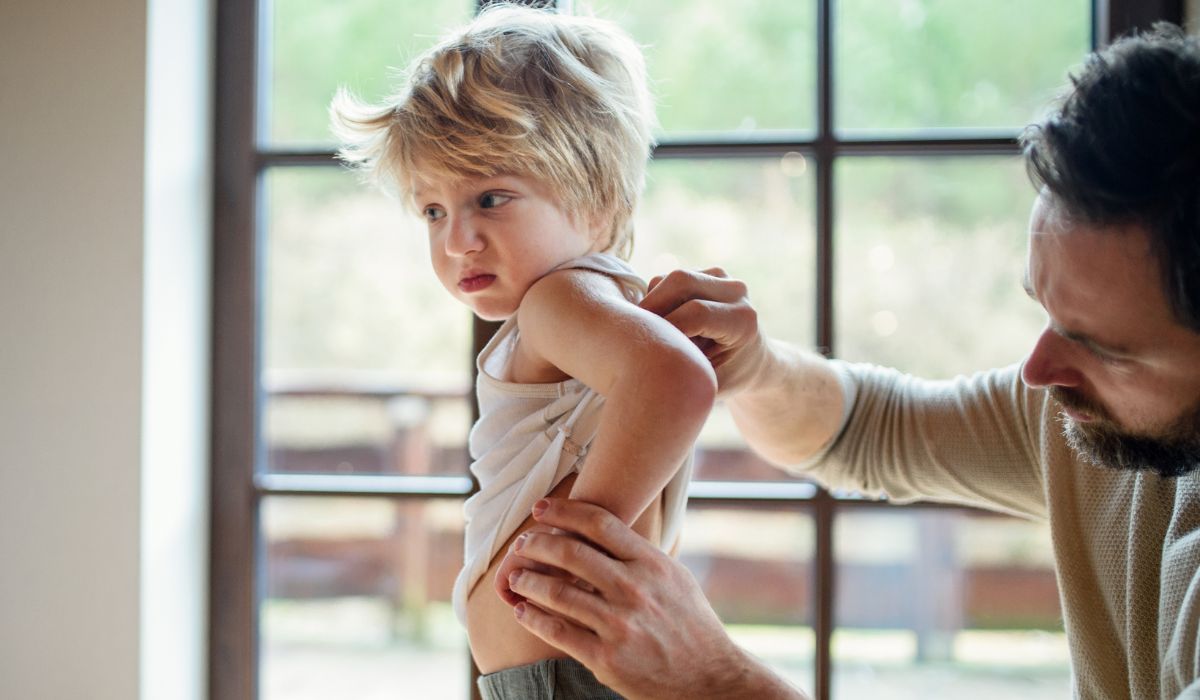 Dad looking at rash on son