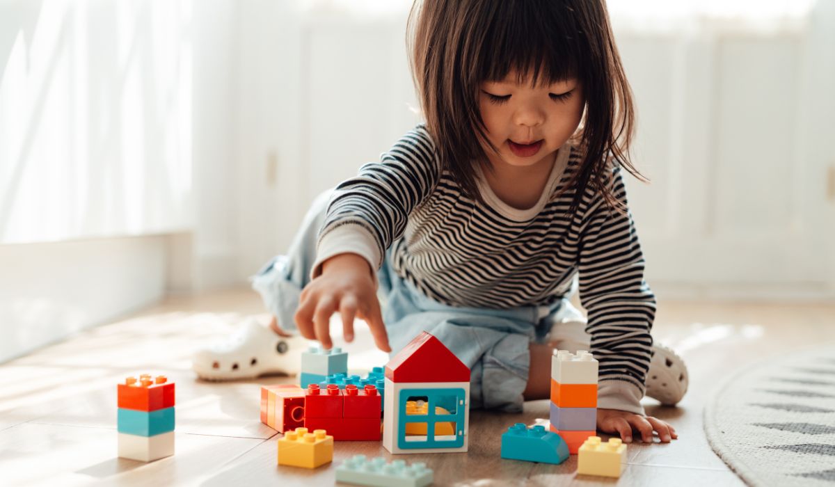 Toddler playing with LEGO