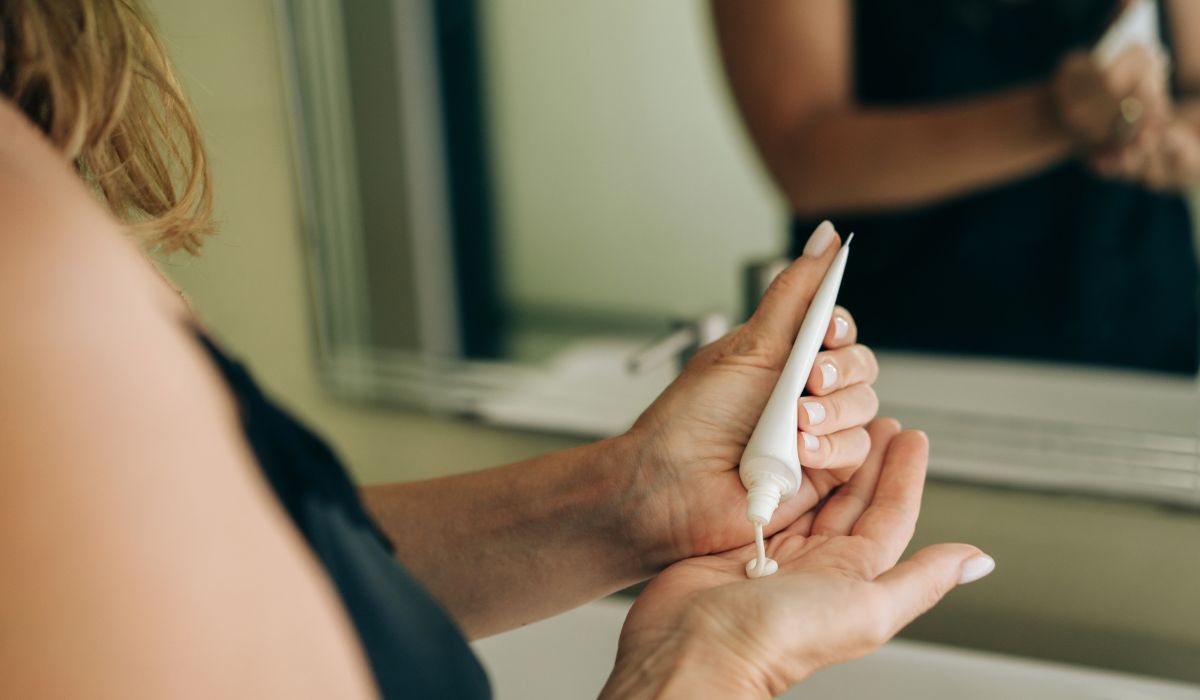 Woman applying moisturiser