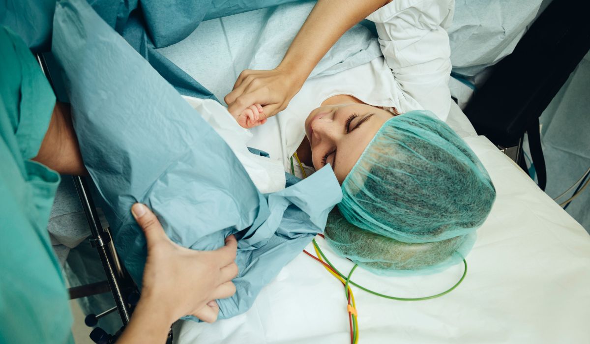 Woman being shown her baby after a C-section