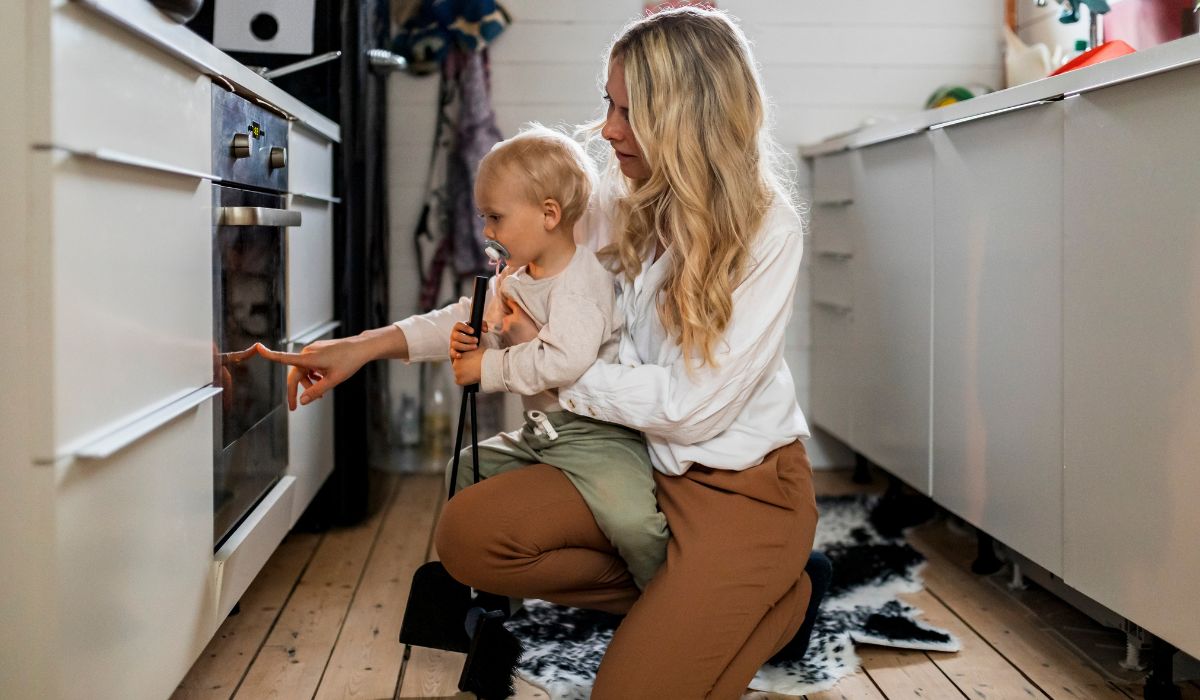 Mother showing her son the oven