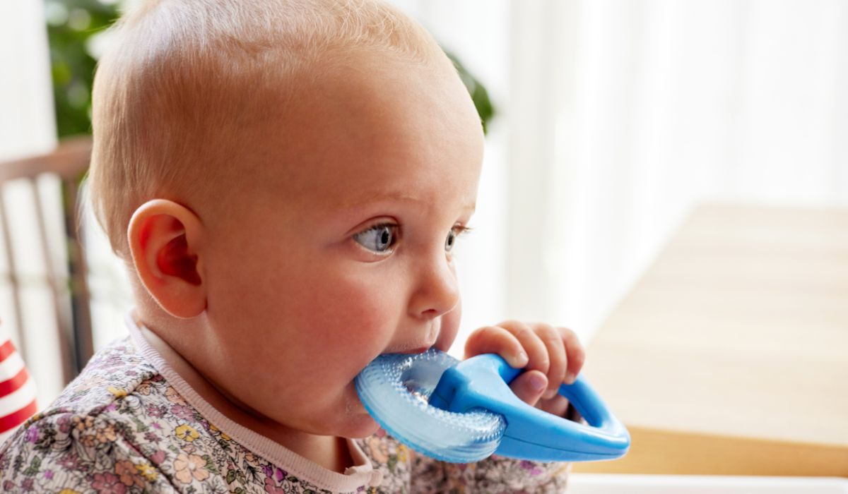 Baby with toy teething