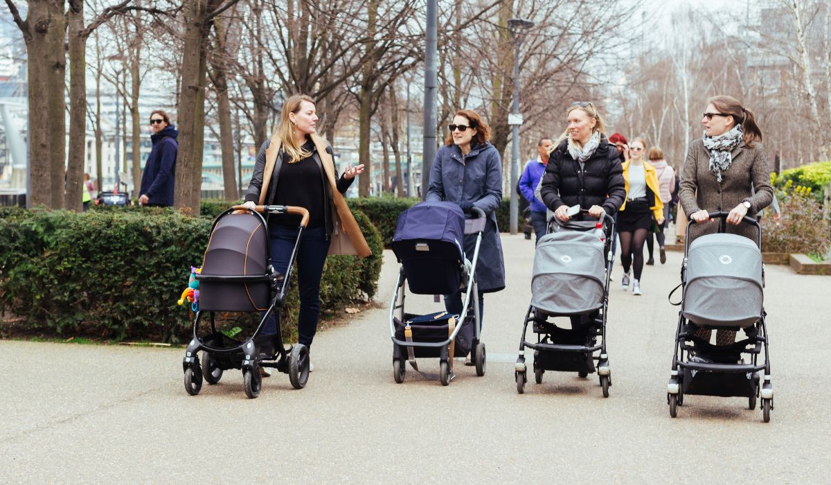 Mums walking in a park with their prams