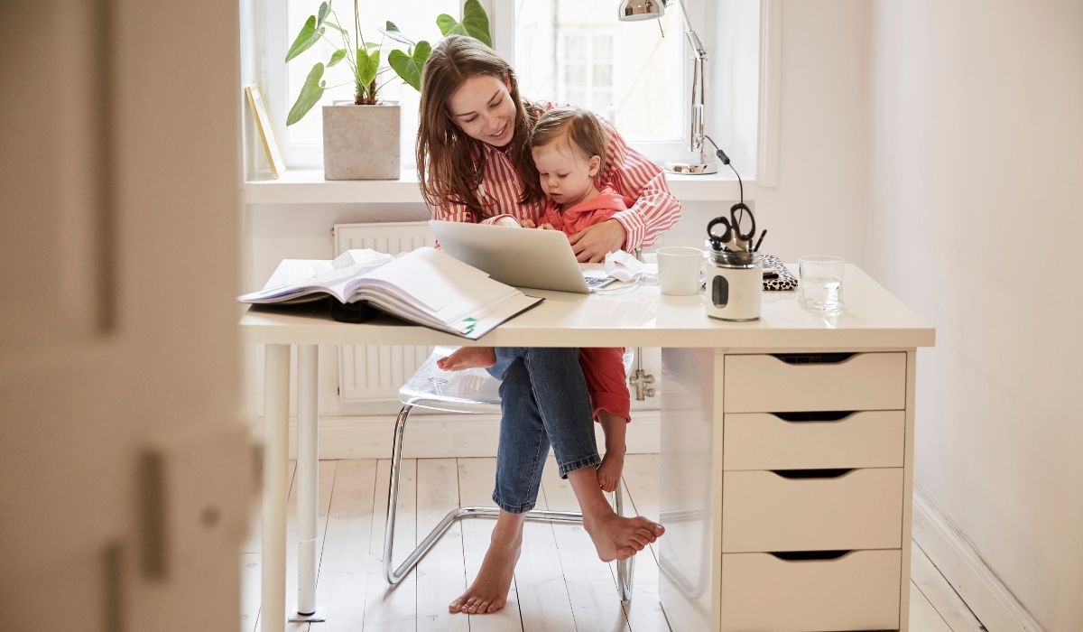 Mother working from home with child