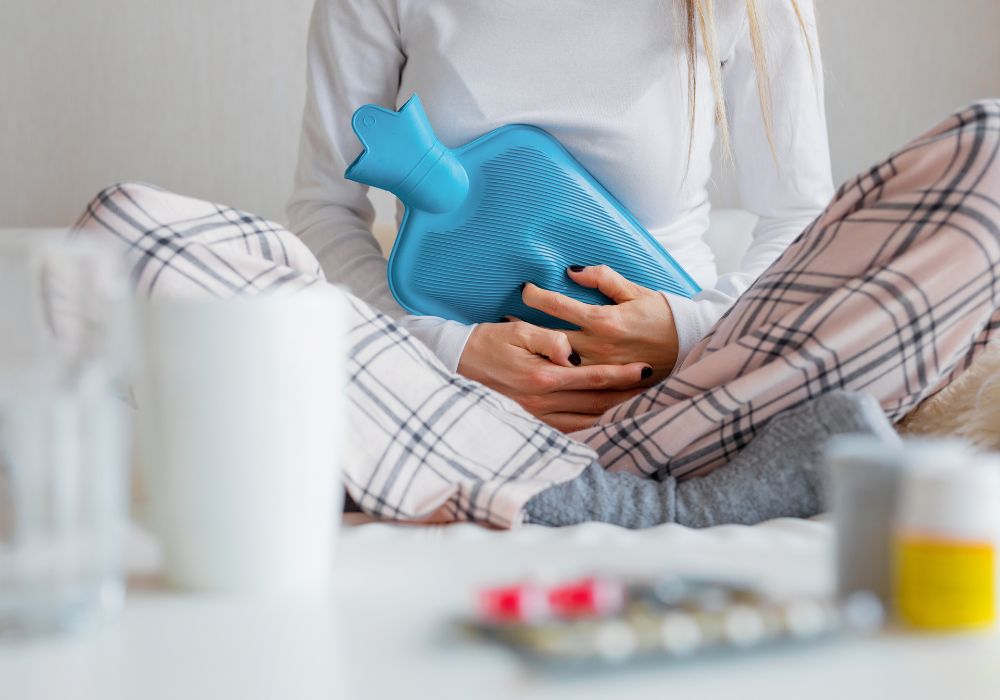 Woman using hot water bottle