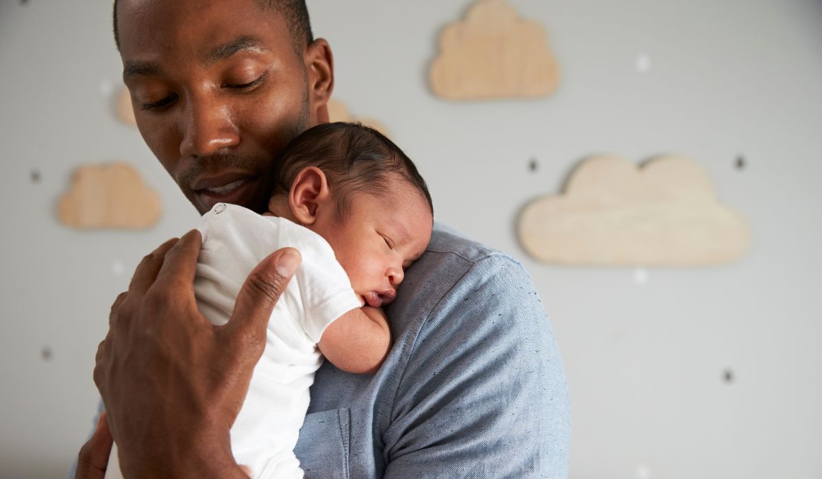 Dad holding his newborn son