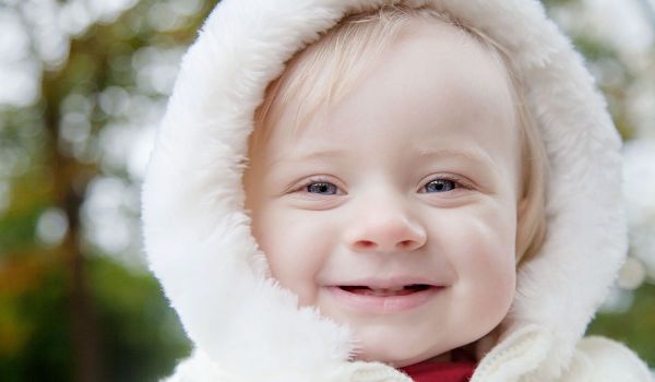 Baby girl with white fluffy jumper hood