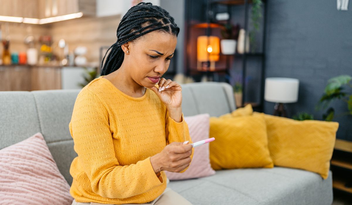 Woman looking at a pregnancy test