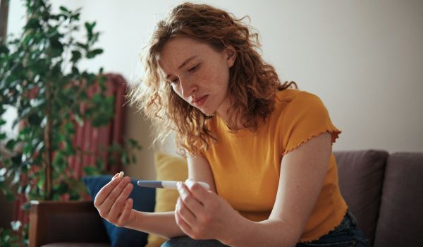 Woman looking at a pregnancy test