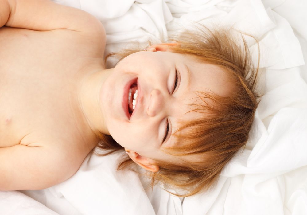 Happy baby in bed