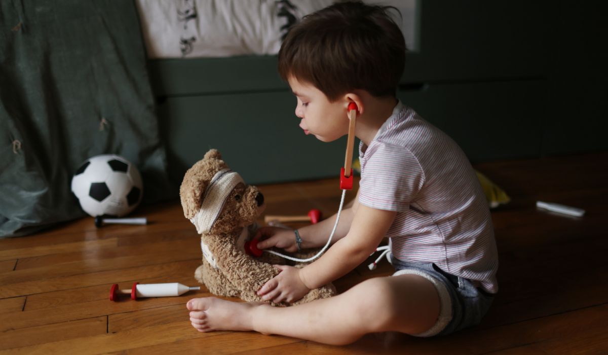 Little boy playing with teddy