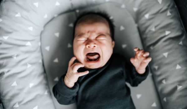 baby crying in bassinet 