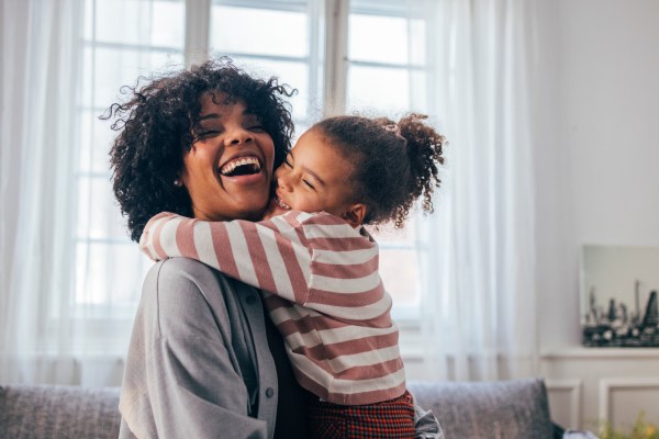 Mum hugging her daughter. 