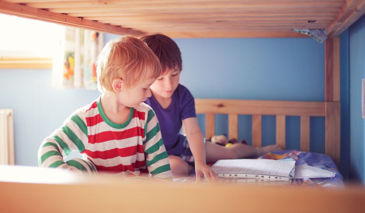 Two boys reading in bed