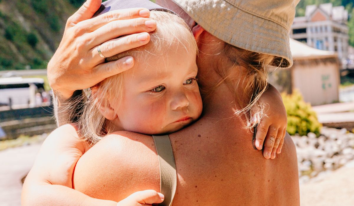Mother holding baby in sun