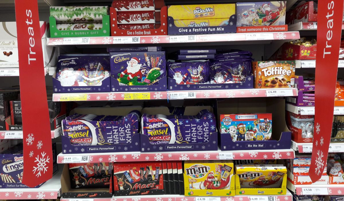 Selection of chocolates and chocolate candy sweets on shelves in store