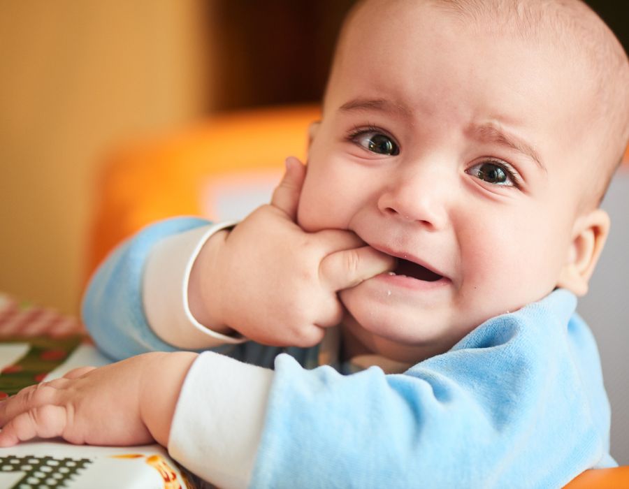 Baby chewing on fingers teething