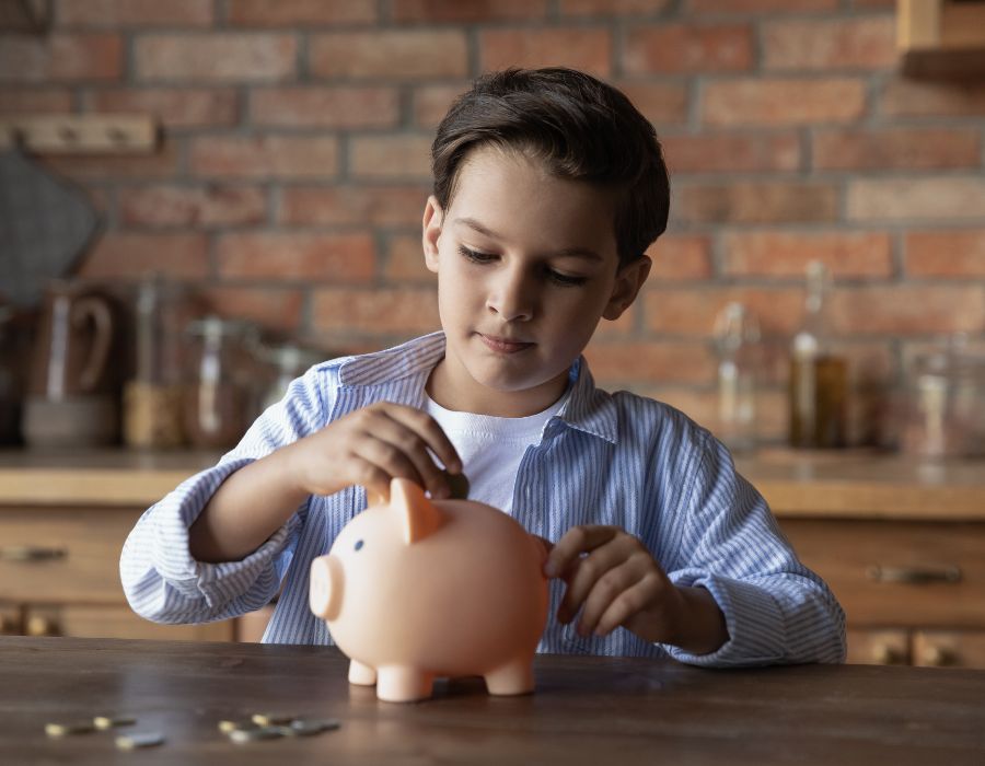 Boy saving money in piggy bank