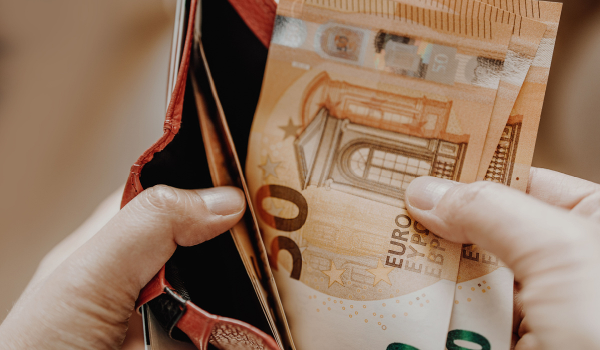 Man counting money in wallet