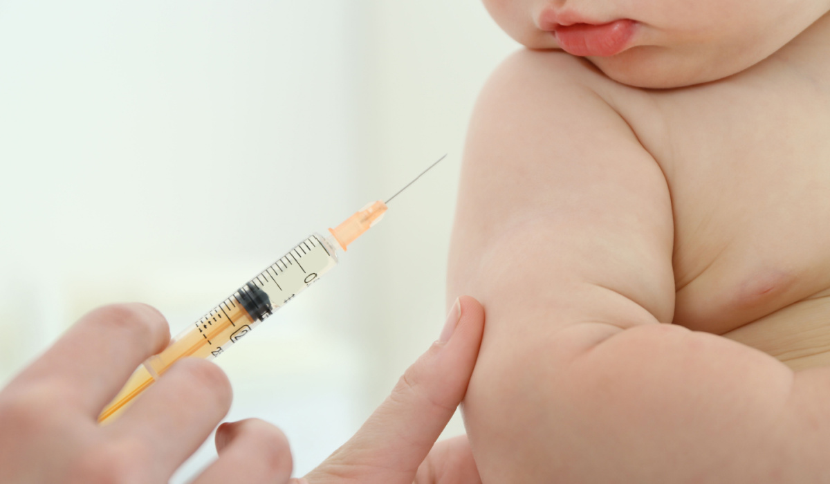 Baby getting injection in arm.