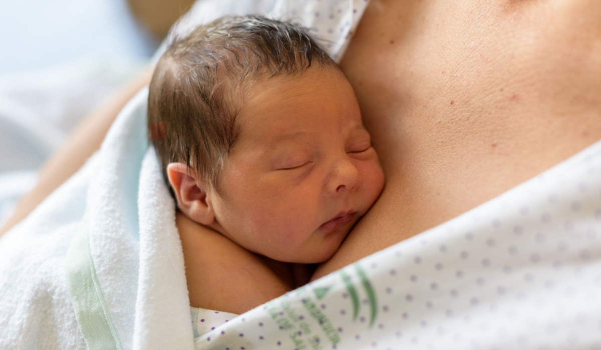 Newborn infant on mother's chest