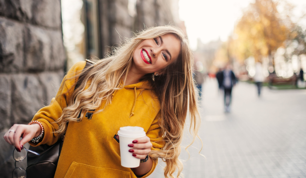 Happy woman smiling outside.