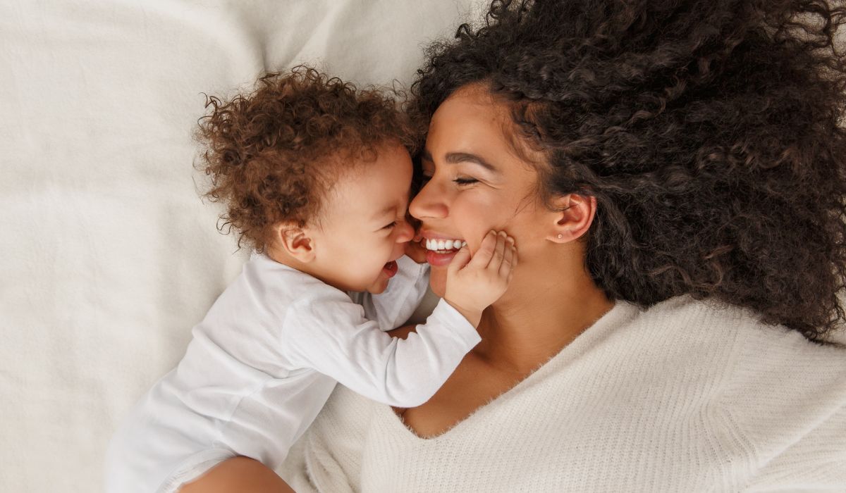 Cute baby and teddy in bed