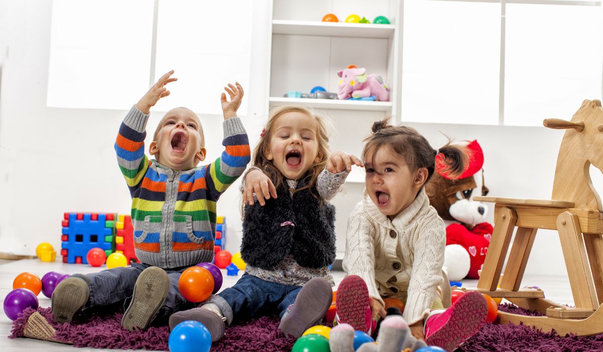 Three happy children in childcare setting