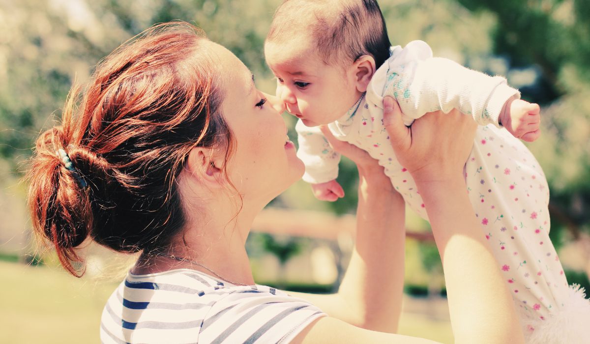 Mother lifting baby