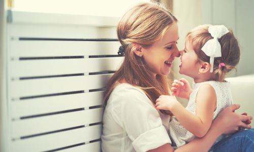 Mother and daughter smile at each other