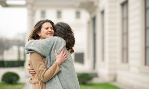 two women hug