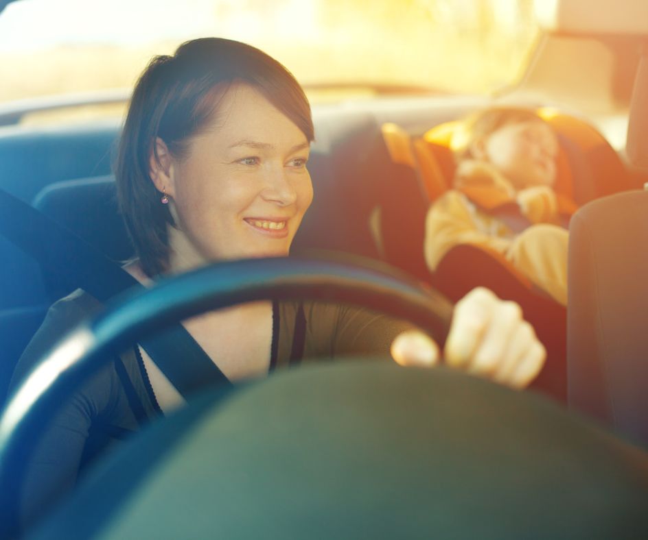 Mother driving with child in back seat