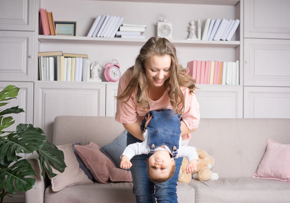 Mother holding baby upside down