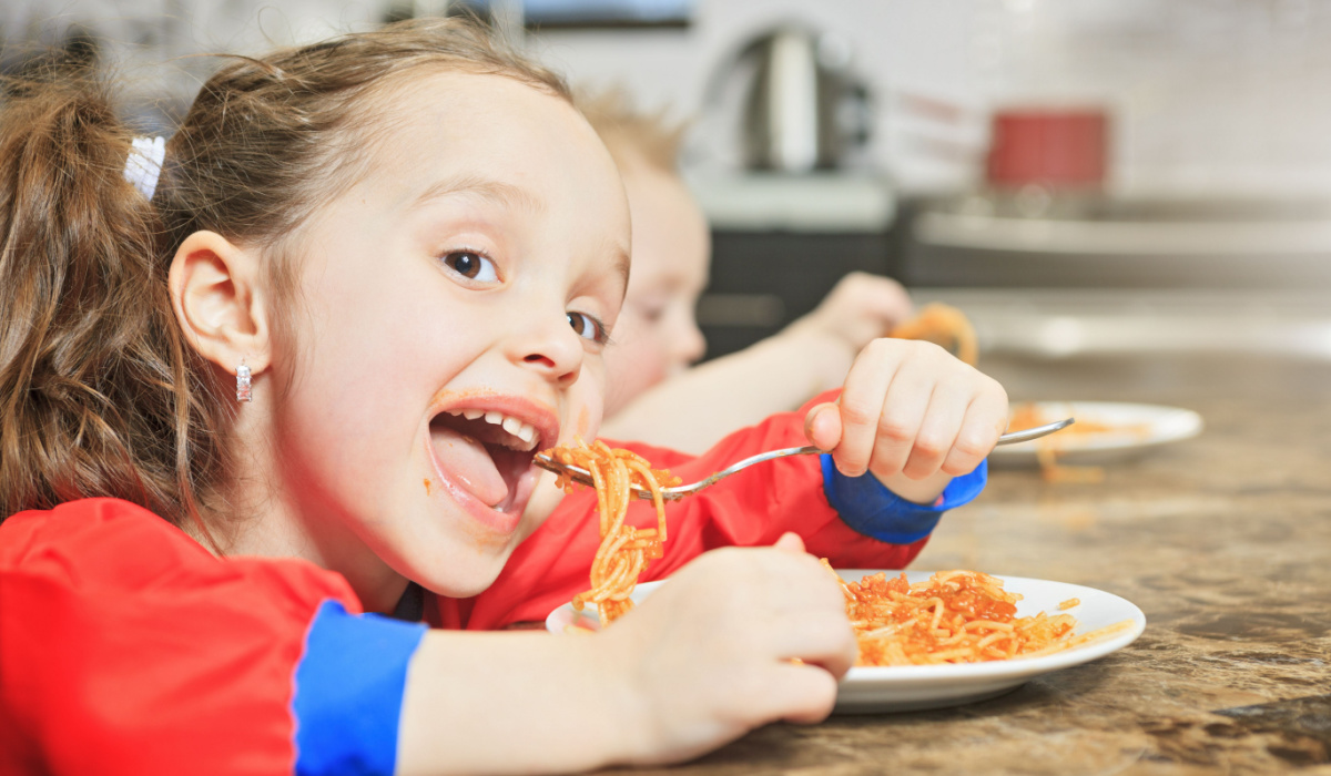 Little girl eating spaghetti