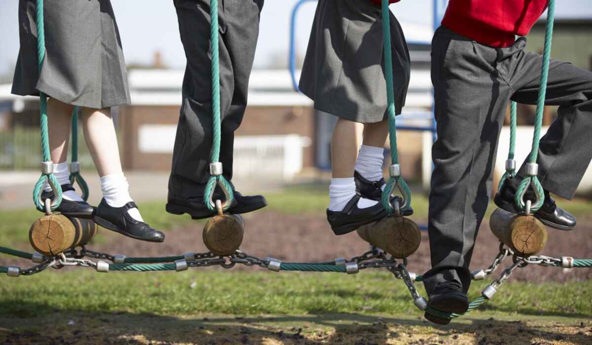Children in school uniforms playing on playground